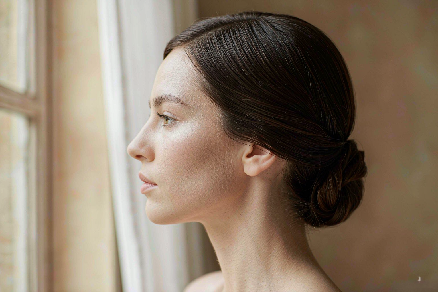 Woman with thick healthy shiny hair and calm scalp in soft light